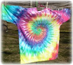 a tie - dyed t - shirt hanging on a clothes line