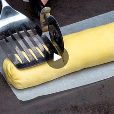 a person using a fork to cut into a banana