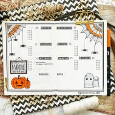 an open halloween planner with pumpkins and bats