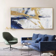 a living room with two blue chairs and a large painting on the wall above it