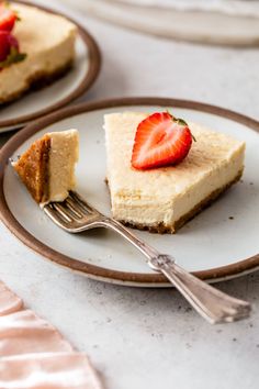 two slices of cheesecake with strawberries on top