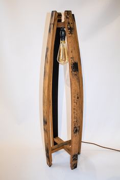 a wooden table lamp with a light bulb on it