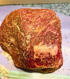 a piece of meat sitting on top of a cutting board