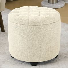 a white ottoman sitting on top of a rug