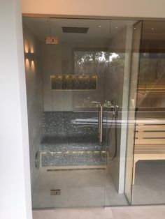 a walk in shower sitting inside of a bathroom