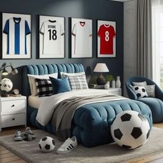 a bedroom decorated in blue and white with soccer themed decor on the wall above the bed