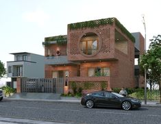 a black car is parked in front of a brick building on the side of the road