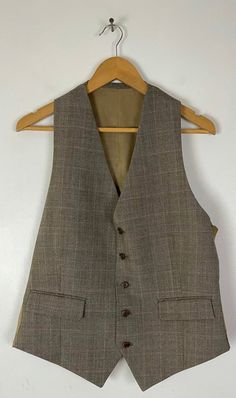 "-Description- >men's brown plaid three piece suit >suit coat has two button front, three buttons on the cuffs, one open and two flap close pockets on the front, double vent in the back, built in shoulder pads, lined >brown striped pocket square >vest is five button front, two flap close pockets on the front, adjustable in the back >pants have button clip & zipper front, belt loops, open pockets in the front, one open and one button close pocket in the back >wool >suit c Fitted Brown Tweed Jacket With Single Button, Brown Fitted Tweed Jacket With Single Button, Fitted Brown Single Button Tweed Jacket, Brown Single Button Fitted Tweed Jacket, Classic Tailored Plaid Three-piece Suit, Classic Plaid Three-piece Business Suit, Classic Brown Outerwear For Wedding, Classic Brown Wedding Outerwear, Brown Notch Lapel Suit With Button Closure