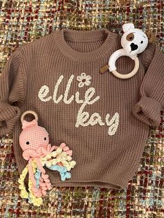 Hand-embroidered personalized baby sweater for the special little one in your life! Name in color of your choice carefully stitched onto a soft long sleeve sweater. Perfect for birth announcement, coming home gift, or monthly photos. Please leave name (up to 7 letters) in the notes to seller box at checkout. If you have any concerns or questions, please contact me. I cannot refund for incorrect spelling. Made in a smoke-free and pet-free home. Chunky Oversized Sweater, Monthly Photos, Stitch Gift, Coming Home Outfit, Personalized Embroidered, Coming Home, Baby Sweaters, Gender Neutral Baby, Personalized Baby