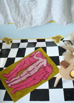 a bathroom with a rug and candle on the floor