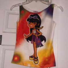 Really Cool Tank Top That’s White Background With Almost A Spray Paint Design On The Top Left Hand Corner In The Bottom Left And Right Corners With A Really Cute Hippie Chick Dress In A White Midriff Purple Shorts A Really Cool Purple Crossover Handbag With Black Fringes Which Happens To Be Beaded And A Yellow Scarf Around Her Neck Which Is Also Beaded And Really Cool Silver And Purple Sunglasses Which Is Also Beaded She Has Long Black Hair Super Cute Platforms In Blue And The Bottom Is Wood The Y2k Stretch Tops For Vacation, White Y2k Beach Top, Cute Fitted Multicolor Tank Top, Cute Multicolor Fitted Tank Top, Multicolor Fitted Crew Neck Tank Top, Fitted Multicolor Crew Neck Tank Top, Fitted White Fun Top, Purple Sunglasses, Yellow Scarf