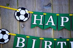 a soccer themed birthday party with green and yellow banner, cupcake toppers and decorations