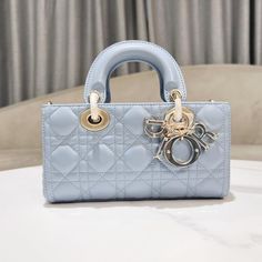 Sky Blue This Lady D-Joy Bag Highlights The Minimalist Aesthetic Of The Lady D Collection, Epitomizing D's Profound Insight Into Elegance And Beauty. Crafted From Sky Blue Lambskin Leather, It Features Eye-Catching Quilting Details With Cannage Stitching, And Its Chic And Elegant Design Is Timeless. The D.I.O.R. Charm Is Made Of Transparent Tonal Resin, Adding A Touch Of Agility To The Exquisite Silhouette. The Small Style Is Equipped With A Detachable Chain Shoulder Strap And An Adjustable And Lady D Joy Bag, Lady D, Chic And Elegant, Dior Handbags, Minimalist Aesthetic, The Lady, Cross Body Bag, Lambskin Leather, Dior Bag