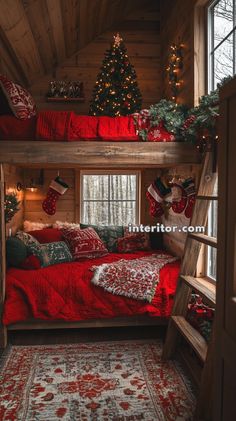 a bedroom decorated for christmas with red bedding and stockings on the top bunk beds