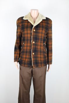 This is the perfect jacket to add to your Winter wardrobe for this cold season, and every chilly day to come. It has a beautifully soft thick faux fur lining, and a very warm woolen plaid exterior. It also has 2 side pockets, a large sherpa collar, and 3 creamy brown buttons down the front. Please note that this jacket has had a few tiny repairs. These can be seen int the last images shown above.  Fabric: 25% Mohair 70% Wool, and 5% Nylon Brand: Alpine. Colour: Dark orange and black check. Size & Measurements: This jacket is a mens size small, or an Australain Womens size 10. Sleeve length: 60cm from shoulder to cuff. Jacket Length: 68cm from collar to hem. Chest: 104cm around chest. Follow Morris and Grant Vintage on Instagram and Facebook to see all new and upcoming vintage items, find o Retro Brown Winter Outerwear, Vintage Outerwear For Cold Weather In Fall, Vintage Outerwear For Cold Fall Weather, Vintage Collared Winter Outerwear, Vintage Winter Outerwear For Cold Weather, Vintage Outerwear For Cold Weather, Retro Brown Outerwear For Cold Weather, Retro Wool Sport Coat For Winter, Vintage Long Sleeve Outerwear For Cold Weather