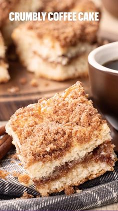 two pieces of crumbly coffee cake on a plate with cinnamon sticks next to it