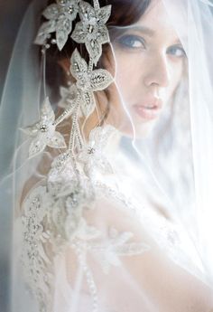 a woman wearing a veil with flowers on it