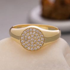 a gold ring with white diamonds on it