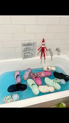 the elf in the bathroom is taking a bath with many pairs of shoes on it