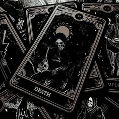 some black and gold playing cards with skeletons on them