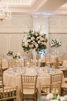 the tables are set with white and blue centerpieces