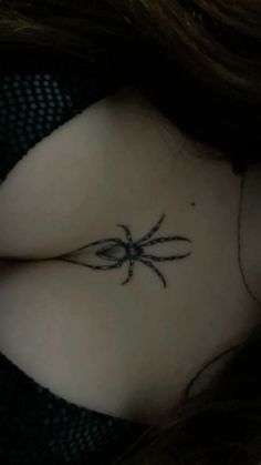 a woman with a spider tattoo on her chest