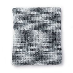 a gray and white blanket sitting on top of a table