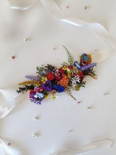 a bunch of flowers that are on top of a white surface with confetti sprinkles