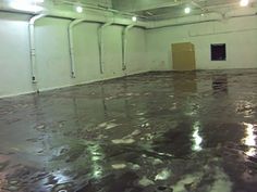 an empty warehouse with water on the floor