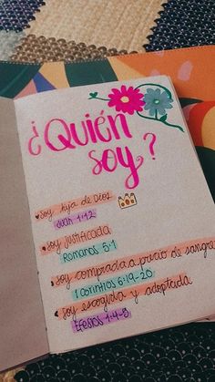 an open notebook with the words quin - soy written in pink on it