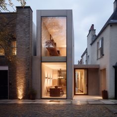 the house is made up of two stories and has glass doors that open to let in light