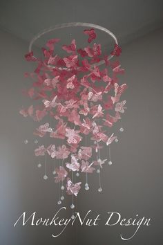 a chandelier with pink butterflies hanging from it