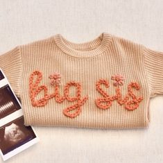 an old sweater with the word goggles written on it next to two photos and a book