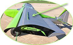 a green and black jet sitting on top of an airport tarmac