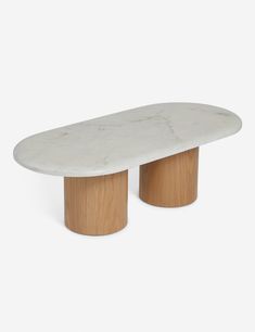 The Shields oval coffee table with an oval marble top and two oak column legs. Long Oval Coffee Table, Nyc Apartment Design, Oval Dining Room Table, Mantel Mirrors, Oval Coffee Table, Cordless Table Lamps, Bright Living Room, Oval Coffee Tables, Dining Benches