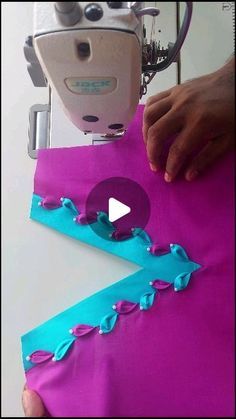 someone is using a sewing machine to sew something on the fabric with blue and purple