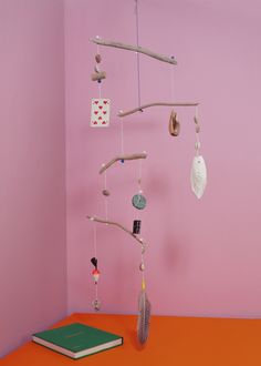 a pink room with an orange table and a book