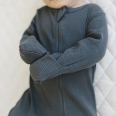 Introducing our zipper footed baby pajamas, designed for ultimate comfort + convenience. Crafted from Organic Cotton ribbed fabric, these pajamas feature a double zipper that zips from the top + bottom, allowing for quick + easy diaper changes. With a range of gender-neutral options, these pajamas are perfect for all babies. The functionality of the zippers makes these pajamas a must-have baby essential, ensuring both practicality + comfort for your little one. Each pajama up to size 6-12 have hand cuffs, + size 6-12 to 18-24 have foot grips. Wash in cold water Fit True to Size 95% Organic Cotton 5% Spandex Measurements in inches from neck to heel: Length: NB 15.5, 0-3m 17, 3-6m 19, 6-12m 20, 12-18m 23 Width: NB 7, 0-3m 8, 3-6m 9,6-12m 9.5, 12-18m 10 Stretch Long Sleeve Onesie For Sleep, Solid Long Sleeve Onesie For Bedtime, Solid Long Sleeve Bedtime Onesie, Gray Long Sleeve Onesie For Loungewear, Hand Cuffs, Eco Friendly Baby, Baby Pajamas, Baby Essentials, Organic Baby