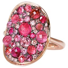 One of a kind Mahenge and Pink Spinel, Pink Tourmaline, Pink Diamond and Ruby Rose Gold Ring, meticulously crafted by Belgian jewellery artist Joke Quick. This extraordinary piece captures the essence of elegance and sophistication with its stunning blend of Pink and red shades. Unlike mass-produced rings, Joke Quick's creations are entirely handcrafted, avoiding any casting or printing techniques. The distinctive feature of these remarkable rings lies in their comfortable fit because of its flat, curved design that contours seamlessly around the finger and their captivating "mosaic setting," where diamonds and gemstones are meticulously placed in such proximity that they form a seamless and breathtaking mosaic pattern. 18K Rose gold 10 g 5 X intense Pink spinels faceted cabochons : 1,27 c Artist Joke, Red Shades, Pink Spinel, Right Hand Rings, Rose Gold Pink, Pave Ring, Ruby Rose, Pink And Red, Pink Diamond