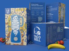 three boxes and one banana on a blue background with strawberries, raspberries, and an unopened can of taco bell