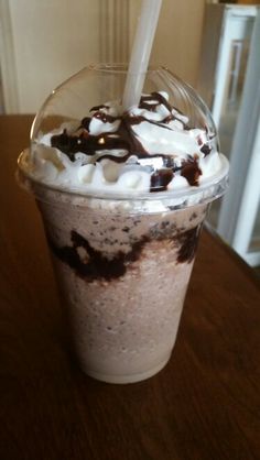 there is a drink with whipped cream and chocolate on the top in a plastic cup