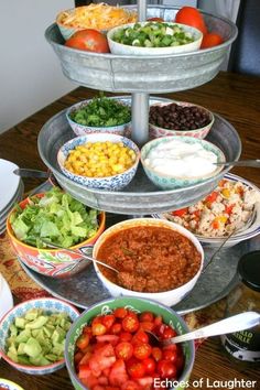 a table topped with bowls filled with different types of food and salads on top of it