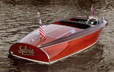 a red speed boat with an american flag on it