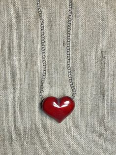 Handmade in Ecuador (Heart 2.5”, .5” thick) Necklace Length: 18 Inches Materials: Tagua, stainless steel chain necklace Due to this item being handmade and the nature of the Tagua Nut the size and the color may vary from piece to piece Unique Red Heart Shaped Jewelry, Red Heart-shaped Sterling Silver Necklace, Handmade Red Heart-shaped Jewelry, Unique Red Heart-shaped Necklace, Red Large Pendant Jewelry For Gift, Red Jewelry With Large Pendant For Gift, Handmade Stainless Steel Jewelry For Valentine's Day, Handmade Red Heart Necklaces, Handmade Heart-shaped Red Necklaces