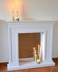 a fire place with candles on top of it