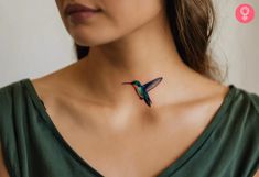 a woman wearing a green dress with a small hummingbird tattoo on her neck and chest