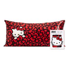 the hello kitty pillow is red and has black circles on it, with an image of a