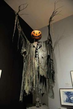 a bathroom decorated for halloween with decorations on the wall and ghost hanging from the ceiling