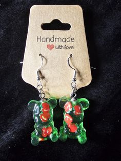 These Apple Fruit Teddy Bear Earrings have a unique combination of glow-in-the-dark gummy bears and adorable apple fruit accents, creating a fun and whimsical accessory that will surely brighten up any outfit. The green apple design adds a fresh, vibrant feel, while the gummy bear charm brings a nostalgic touch of sweetness. The standout feature of these earrings is their glow-in-the-dark effect. The gummy bear and apple fruit accents emit a soft glow in low light, making them perfect for evening events, parties, or simply adding a magical touch to your day-to-night look. These earrings are designed to sparkle in the light, drawing attention with their fun, glowing details. Perfect for anyone who loves unique, playful jewelry, these Apple Fruit Teddy Bear Earrings are a must-have. The comb Teddy Bear Earrings, Gummy Bear Earrings, Playful Jewelry, Whimsical Accessories, Bear Earrings, Apple Fruit, Apple Design, Sparkle Earrings, Fruit Design