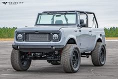 an off - road vehicle is parked in a parking lot